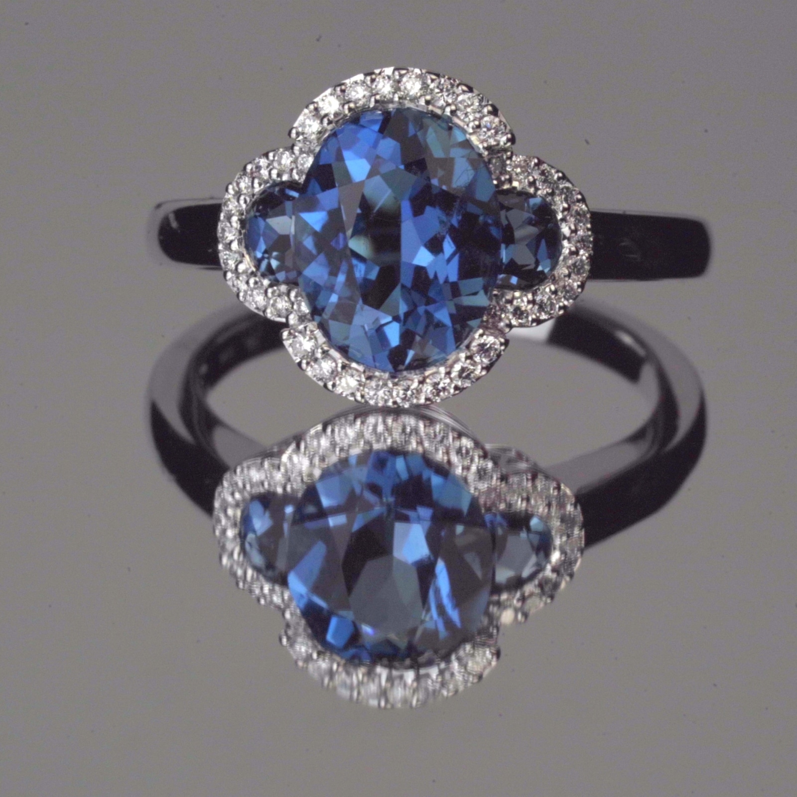 Solitaire sapphire ring with surrounded by diamonds