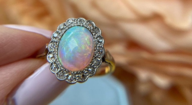 Opal engagement ring with diamond halo