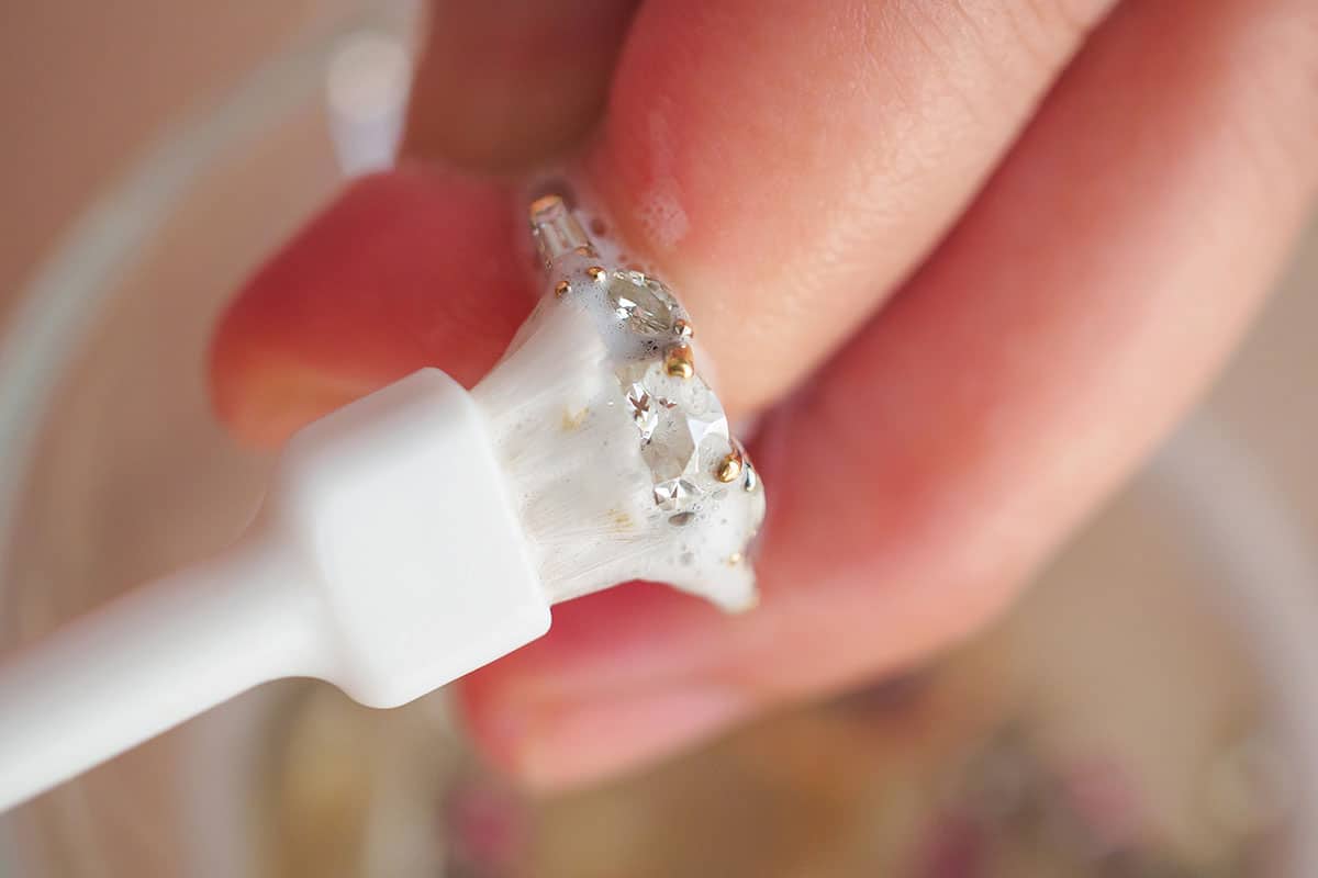 using harsh chemicals to clean three stone diamond engagement ring
