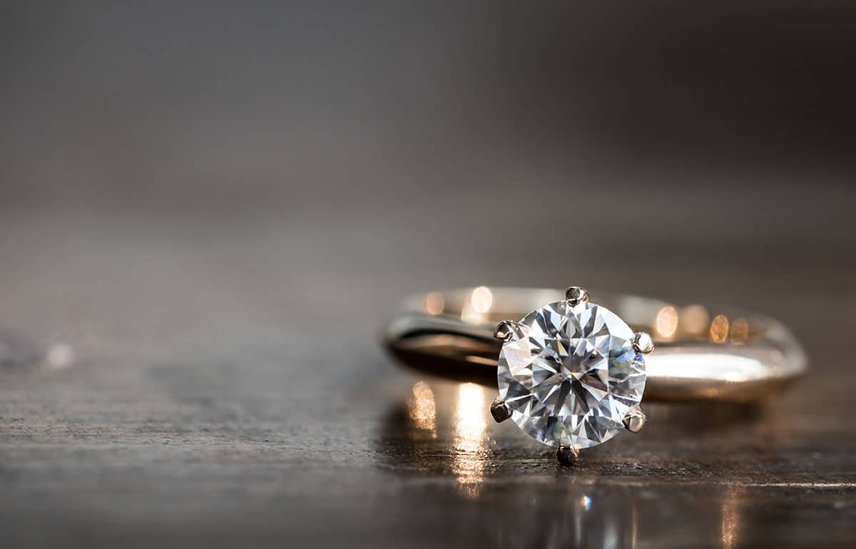 Engagement ring with round diamond center stone