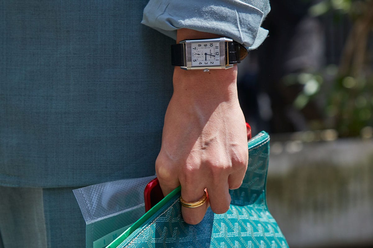 Man with green Goyard bag and Jaeger Le coultre Reverso watch