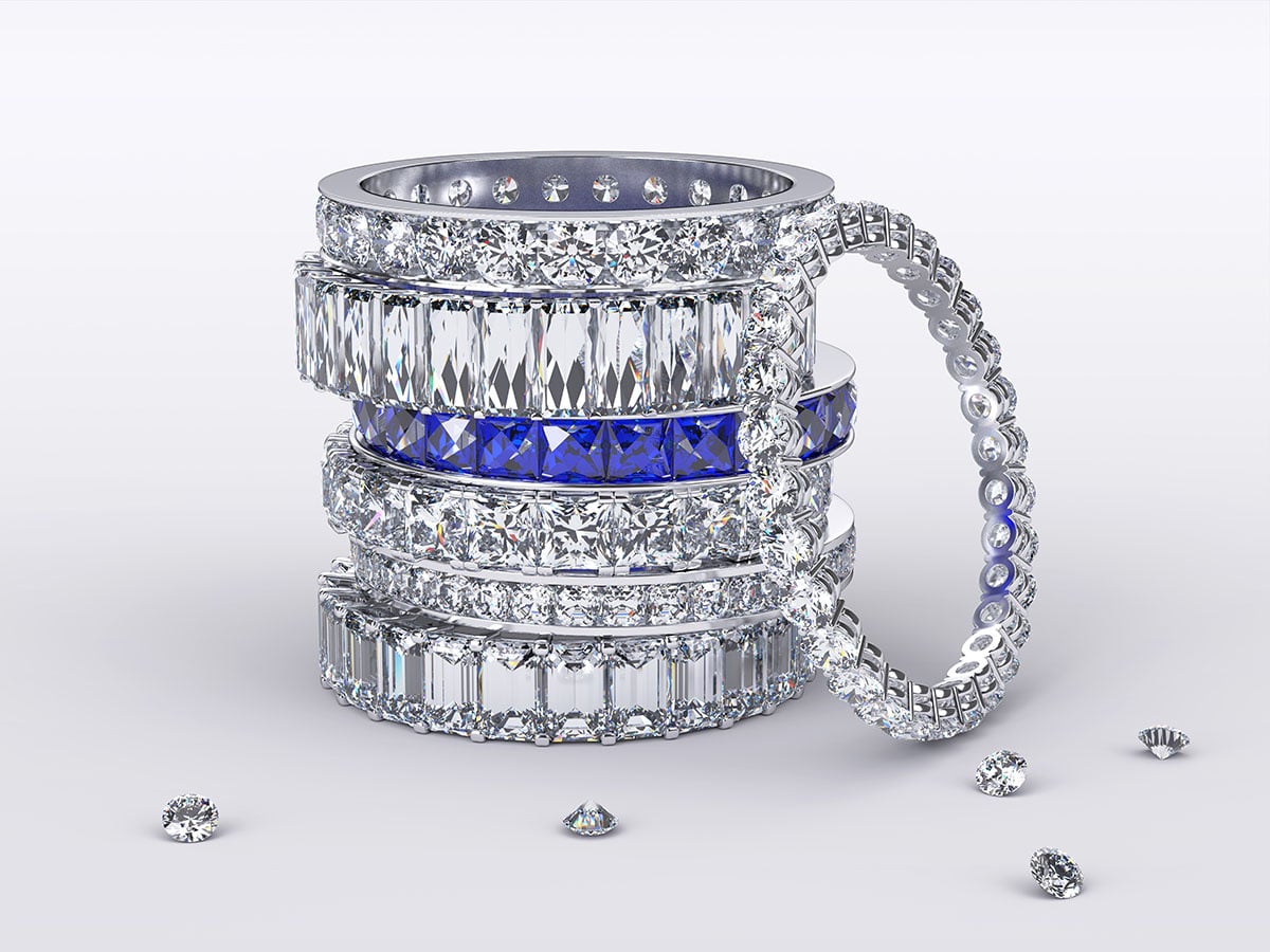 image of a stack of white and blue diamond eternity rings