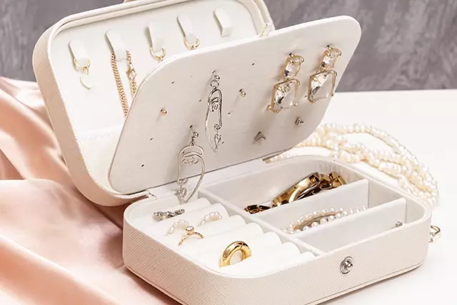 Various jewelry in an open compartmented jewelry box