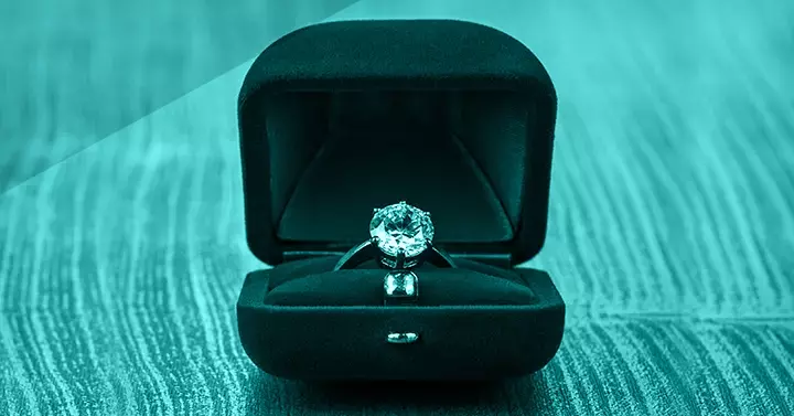 Diamond solitaire ring inside a blue felt-lined box