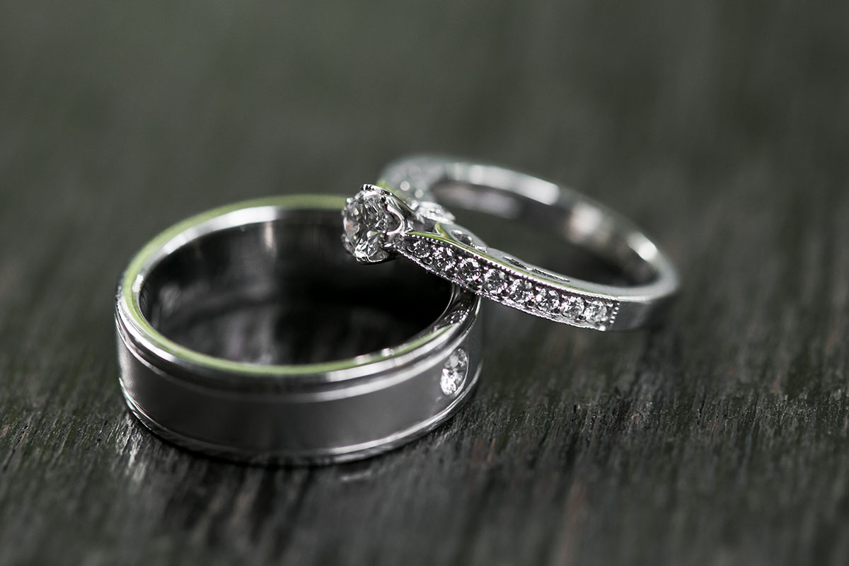 Platinum engagement ring and wedding band on black background
