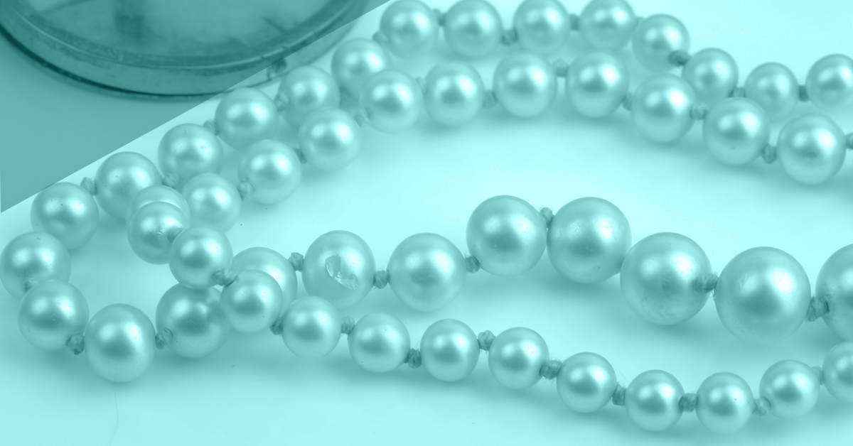 a string of pearls on a white background