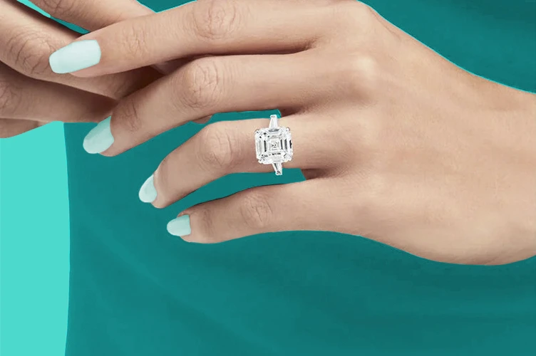 A ring with an emerald cut diamond 