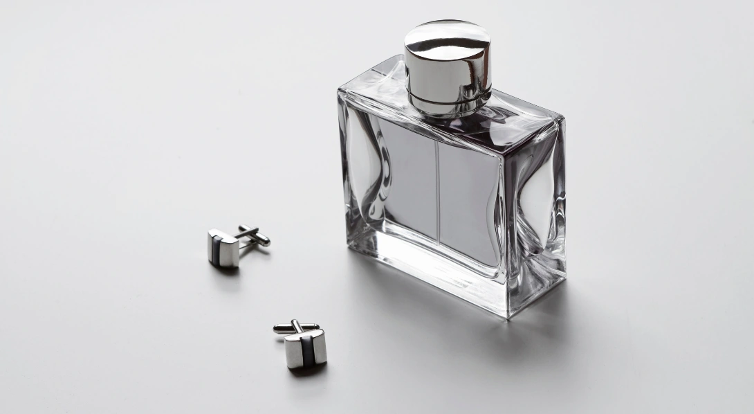 Cufflinks next to bowtie and pen