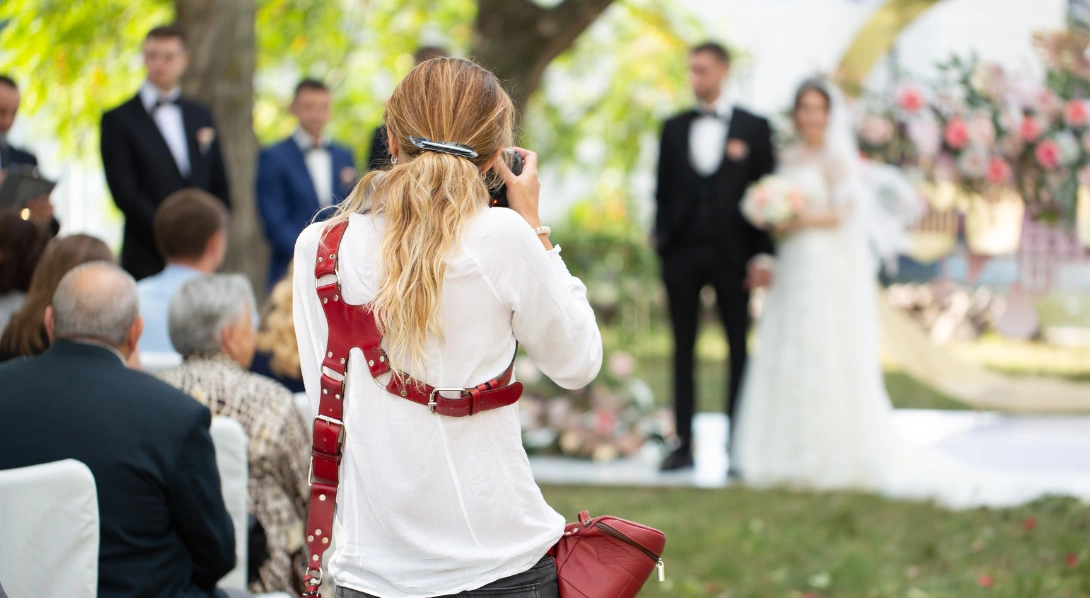 Photographer taking photo of wedding couple