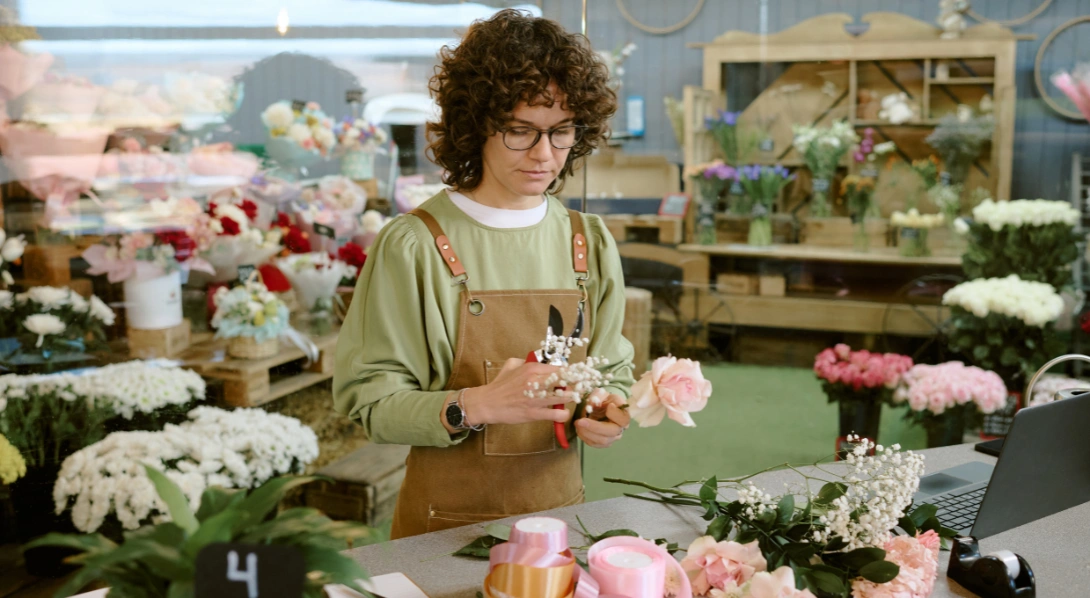 Florist putting together flower arrangement