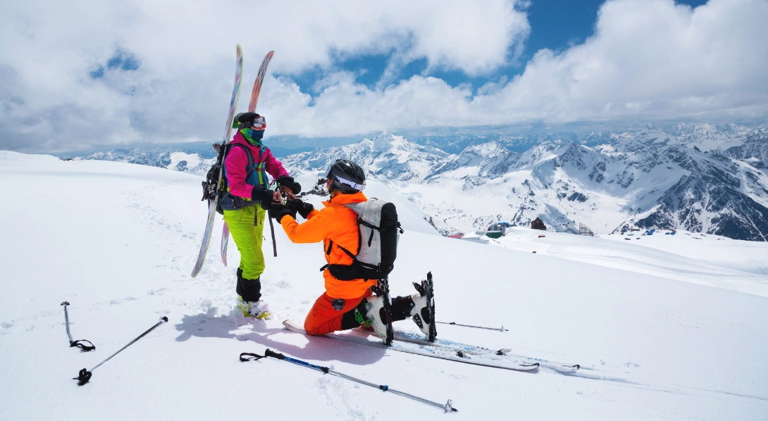 Man and woman in ski gear with man proposing