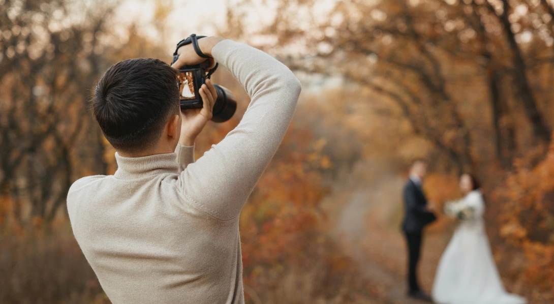 Wedding photographer taking photos of bride and groom