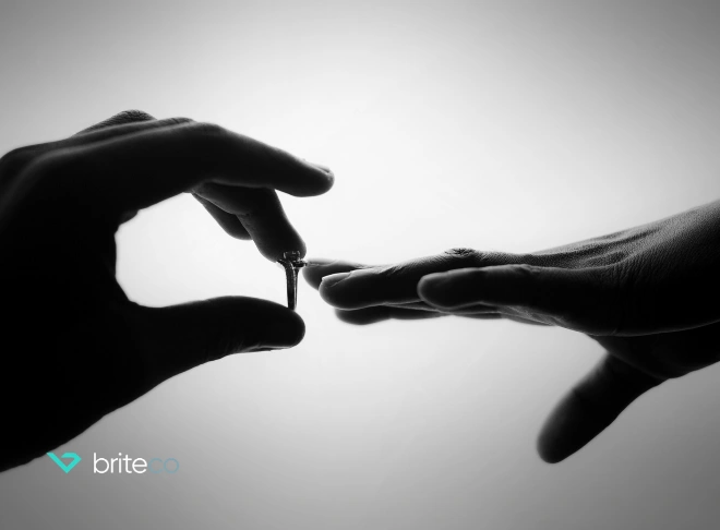 Fingers holding engagement ring