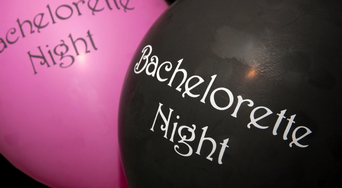 Woman holding ring balloon at bachelorette party