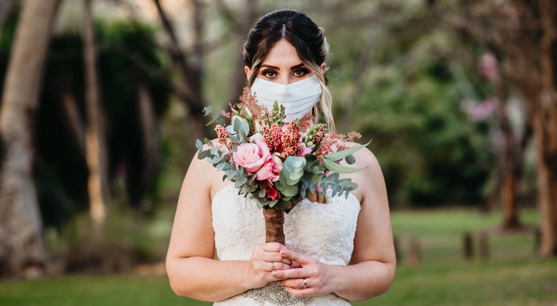 Bride holding face mask
